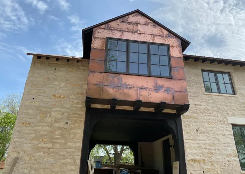 Copper metal panel facade on a stone building for Skylight Installation in La Habra Heights